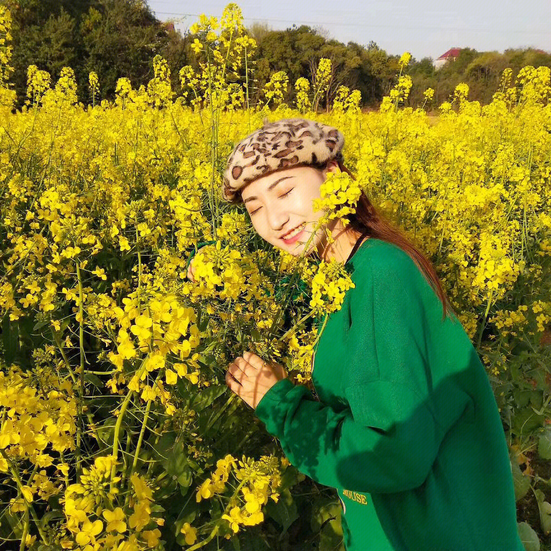 油菜花地拍照穿驼色图片