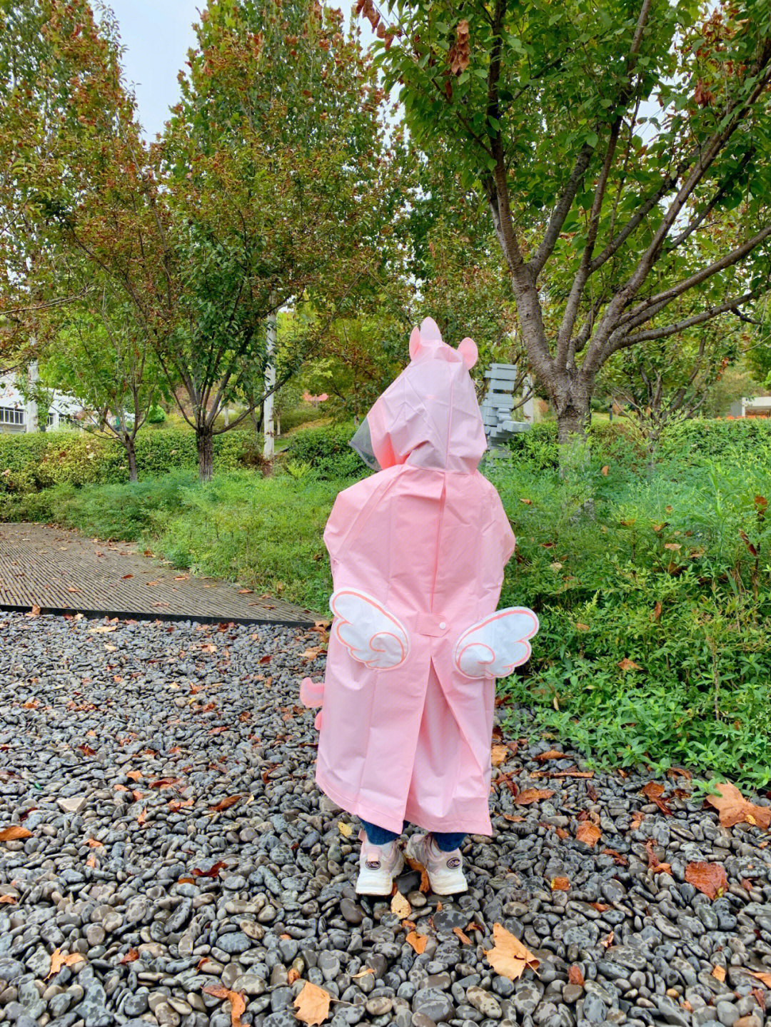 人外出享受这难得的凉爽女儿穿上了小鹿米利的粉色雨衣在路上蹦蹦跳跳