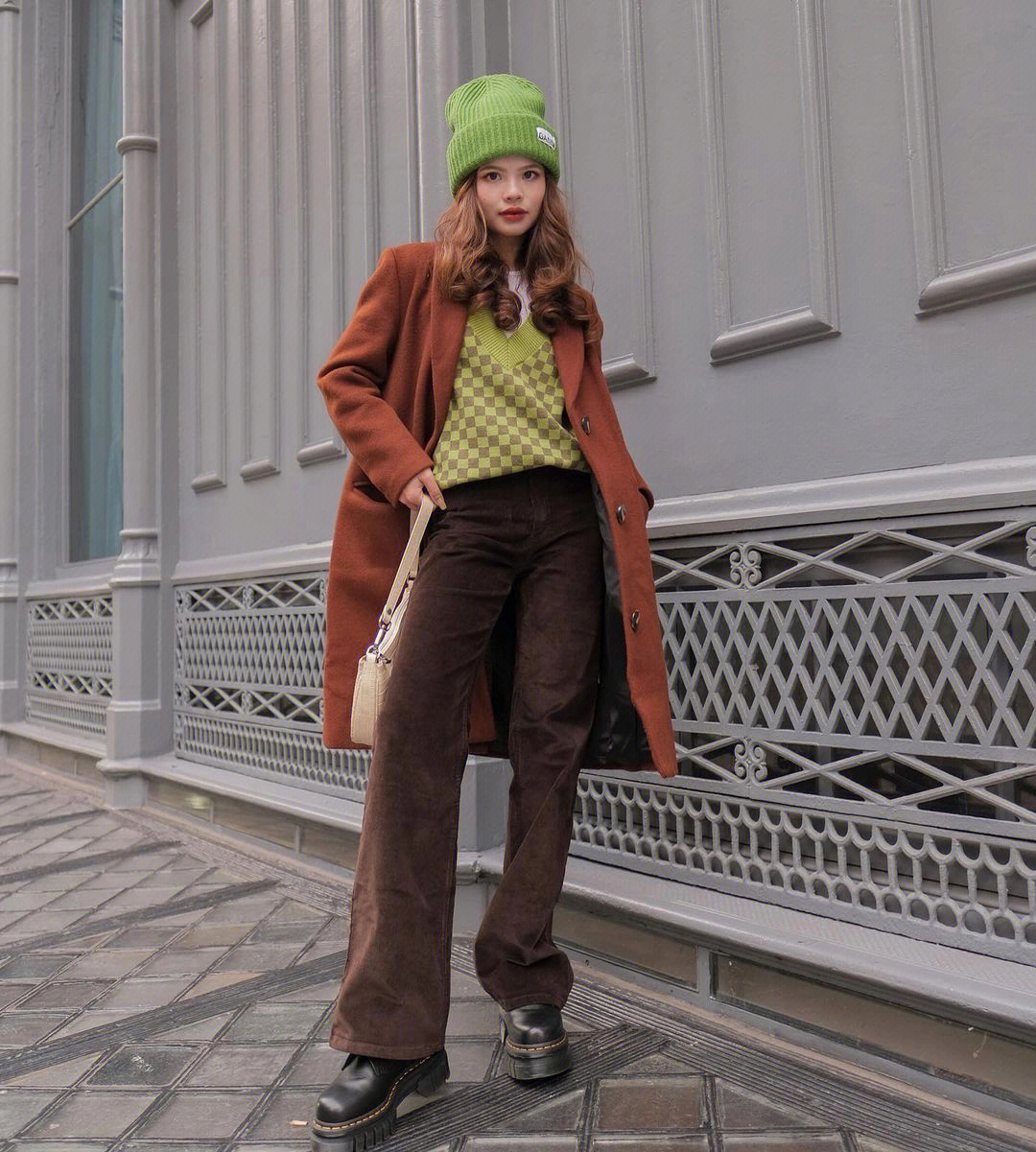 焦糖色外套,来搭配深棕色阔腿裤和厚底马丁靴绿色的内搭帽子让人眼前