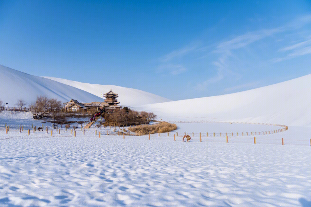 雪是画笔,勾勒出冬日月牙泉刚柔并济的轮廓.泉水碧绿,荒漠披雪